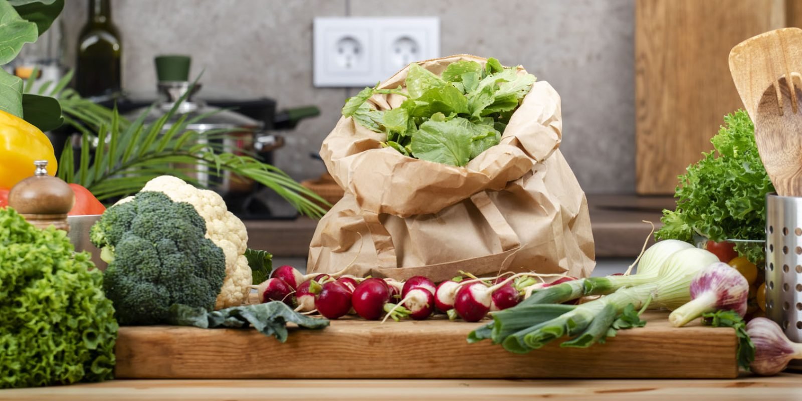 selection of fresh vegetables including broccoli, lettuce, and radishes on wooden countertop in a clean kitchen